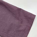 Close-up of a smooth, purple fabric with a subtle sheen, ideal for high-end fashion garments and accessories.