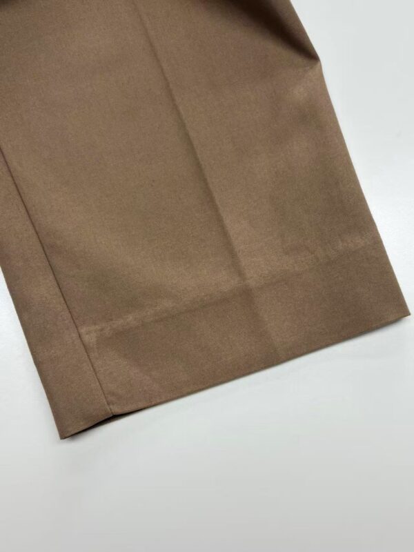 Close-up of a smooth, brown fabric with a clean hem, suitable for fashion and clothing projects.