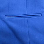 Close-up of a blue suit jacket with a neatly stitched horizontal pocket, showcasing fine tailoring and fabric quality.