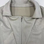 Close-up of a stylish light gray leather jacket with a front zipper and collar, perfect for fashion-forward women seeking versatile outerwear.
