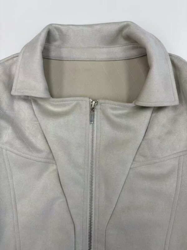 Close-up of a stylish light gray leather jacket with a front zipper and collar, perfect for fashion-forward women seeking versatile outerwear.