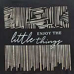 Black T-shirt featuring a modern geometric design with the phrase "Enjoy the little things" in stylish fonts.