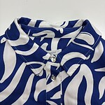 Close-up of a stylish blue and white patterned shirt with a collar and buttons, perfect for casual or semi-formal wear.