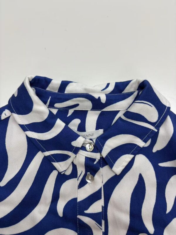 Close-up of a stylish blue and white patterned shirt with a collar and buttons, perfect for casual or semi-formal wear.