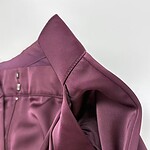 Close-up of a stylish burgundy blazer with detailed stitching and smooth fabric, perfect for professional or formal occasions.