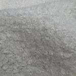 Detailed close-up of curly gray hair showing fine, soft, and dense curls with a natural shine, ideal for hair care and styling content.