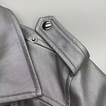Detailed close-up of a gray leather jacket shoulder with button and stitching, showcasing high-quality craftsmanship and stylish design.