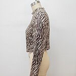 Close-up of a women's animal print knit sweater displayed on a mannequin, showcasing the detailed pattern and cozy texture.