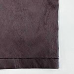 Detailed view of burgundy leather fabric with visible texture and stitching, ideal for fashion and accessory design.