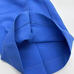 Close-up of a vibrant blue fleece hoodie showing the fabric texture and stitching details, perfect for casual and sportswear.