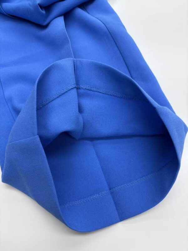 Close-up of a vibrant blue fleece hoodie showing the fabric texture and stitching details, perfect for casual and sportswear.