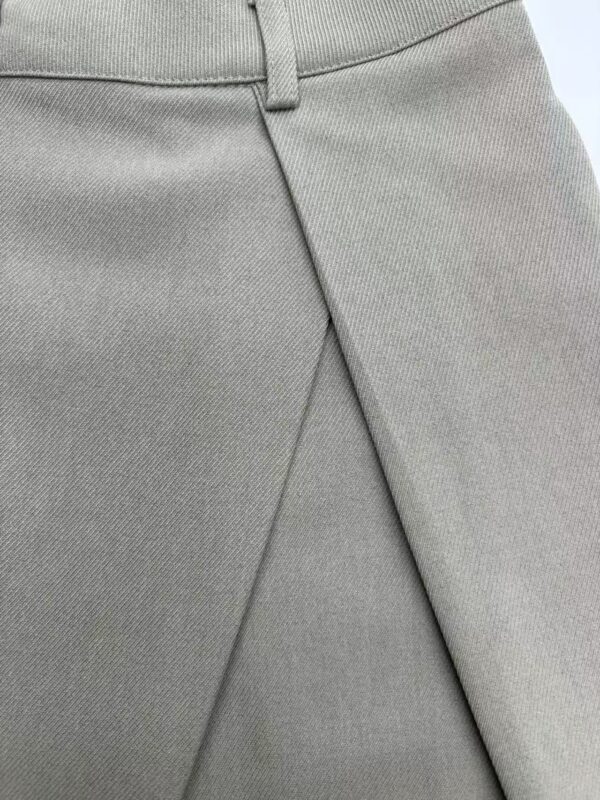 Close-up of light gray men's trousers showing fabric texture and tailored fit, ideal for business or formal wear.