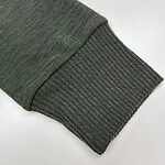 Close-up of a green sweatshirt sleeve with ribbed cuff, showcasing comfortable casual wear for men and women.