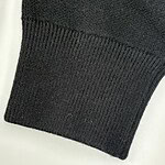Detailed view of a black sweater cuff showing ribbed knit texture and fabric quality, ideal for fashion and clothing product listings.