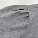 Close-up of a grey fabric sleeve showing detailed stitching and texture, ideal for fashion and clothing product images.