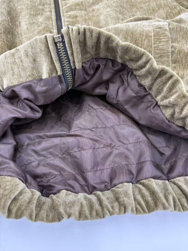 Close-up of a beige casual hoodie with a zipper and purple lining, showcasing comfortable fabric and stylish design.