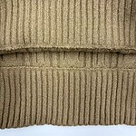 Close-up of a beige cable knit sweater with ribbed cuffs and intricate cable patterns, showcasing high-quality knitwear suitable for cold weather.