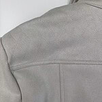 Close-up of a light grey fleece jacket showing texture and stitching details, ideal for outdoor or casual wear.
