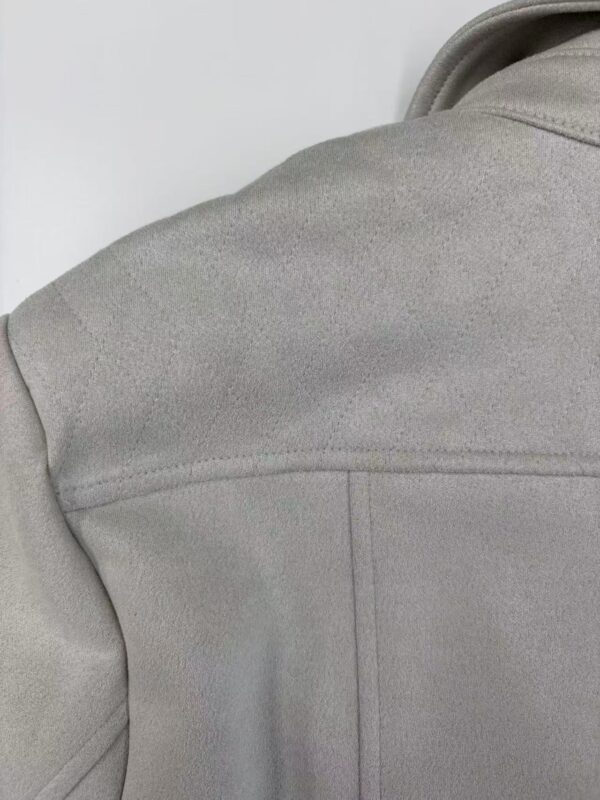 Close-up of a light grey fleece jacket showing texture and stitching details, ideal for outdoor or casual wear.