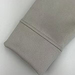 Close-up of a beige fabric sleeve with a clean seam, showcasing smooth texture and high-quality material, ideal for fashion or clothing design.