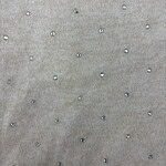 Close-up of beige fabric with small, shiny beads creating a subtle, elegant pattern, ideal for high-end fashion or accessories.