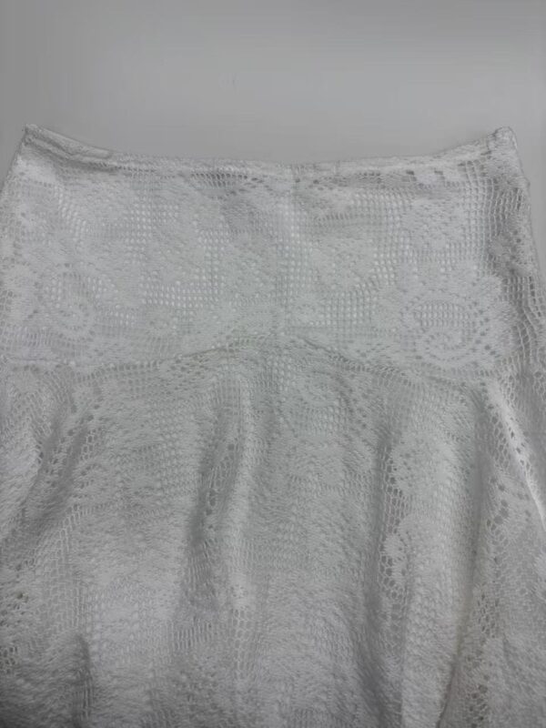 Elegant white lace skirt with intricate floral patterns, perfect for summer or special occasions, showcasing delicate craftsmanship and stylish design.