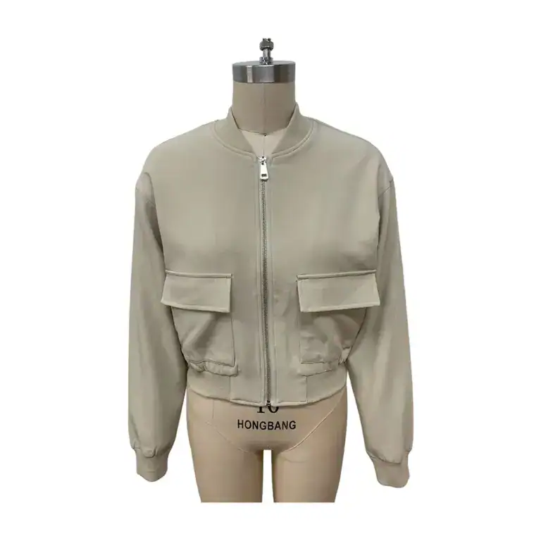 Stylish beige bomber jacket with front zipper and large flap pockets, perfect for casual wear and fashion-forward outfits.