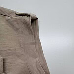 Close-up of beige casual men's pants showing fabric texture and stitching details, ideal for comfortable everyday wear.