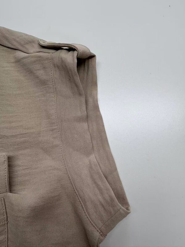 Close-up of beige casual men's pants showing fabric texture and stitching details, ideal for comfortable everyday wear.