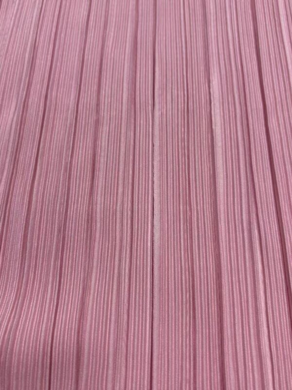 Close-up of pink fabric with vertical striped pattern, ideal for fashion and clothing projects.