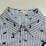 Close-up of a blue and white striped shirt with small black bow patterns, featuring a classic collar and button-down front, perfect for casual or office wear.