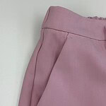 Close-up of pink women's pants with a tailored fit, featuring a side pocket and smooth fabric, perfect for casual or semi-formal wear.
