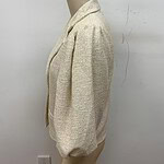 Stylish cream textured blazer with puffed sleeves, perfect for formal or casual wear, displayed on a mannequin against a plain white background.