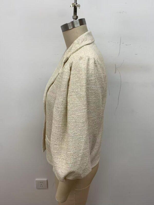 Stylish cream textured blazer with puffed sleeves, perfect for formal or casual wear, displayed on a mannequin against a plain white background.