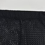 Detailed close-up of black lace fabric with intricate pattern, suitable for fashion and clothing design.