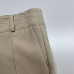 Close-up of beige women's trousers showing tailored fit and high-quality fabric, ideal for professional or casual wear.