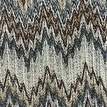 Close-up of a textured fabric featuring a zigzag pattern in shades of brown, beige, black, and white, showcasing intricate weaving details.