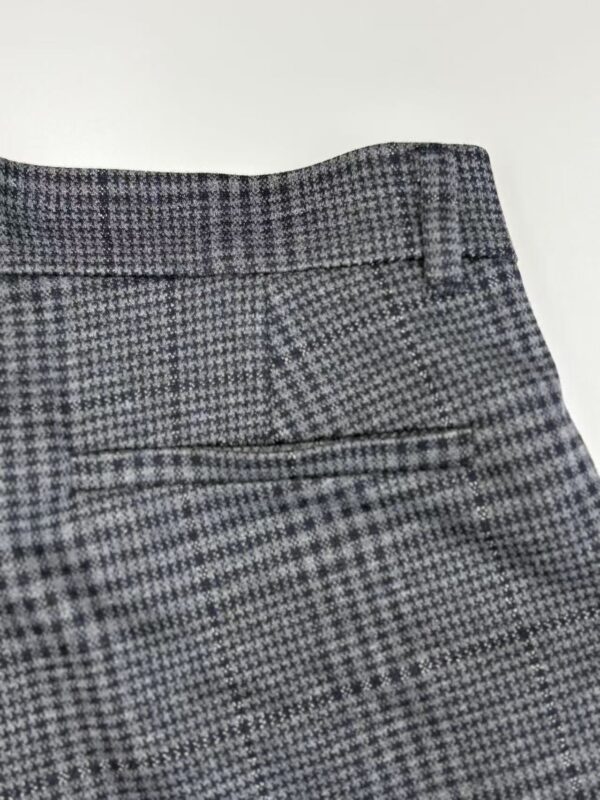 Close-up of stylish gray checkered dress pants with a tailored fit, suitable for formal occasions and office wear.