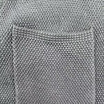 Close-up of a textured fabric pocket on a garment, showcasing detailed stitching and pattern in neutral tones.