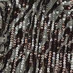 Close-up of sequin fabric featuring black, silver, and rose gold sequins arranged in wavy patterns for a glamorous look.