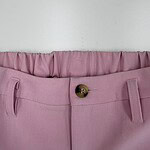 Close-up of pink women's trousers with a button and belt loops, showcasing stylish and comfortable fashion wear.
