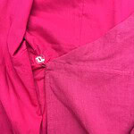 Close-up of vibrant pink fabric showcasing texture and stitching details, ideal for fashion and clothing design.