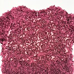Decorative wall art made of pink roses arranged in a heart shape, perfect for romantic or floral-themed interior decoration.