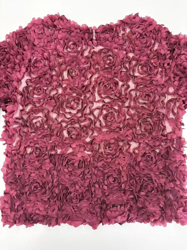 Decorative wall art made of pink roses arranged in a heart shape, perfect for romantic or floral-themed interior decoration.