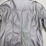 Elegant silver leather jacket with detailed stitching, perfect for fashion-forward women seeking a trendy and versatile outerwear piece.