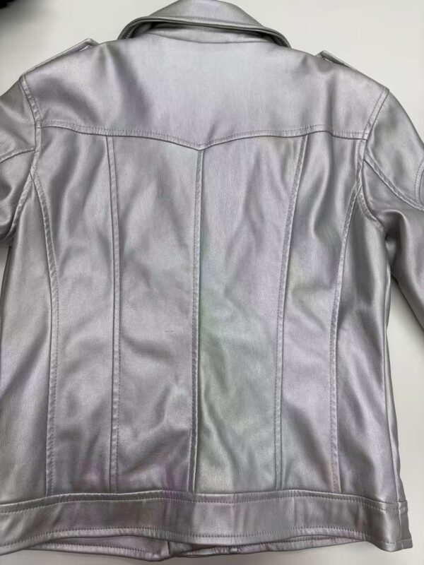 Elegant silver leather jacket with detailed stitching, perfect for fashion-forward women seeking a trendy and versatile outerwear piece.