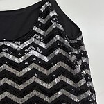 Elegant black dress with silver sequins in a zigzag pattern, featuring thin spaghetti straps, perfect for evening wear or special occasions.