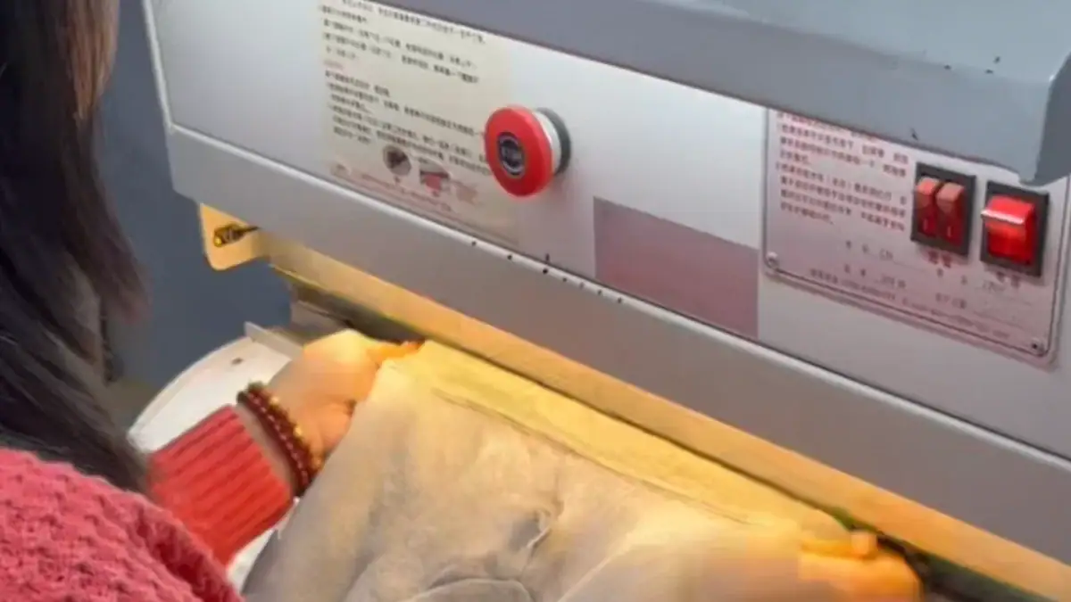 Close-up of a linking machine used for sewing and repairing loose sweater seams in apparel manufacturing.