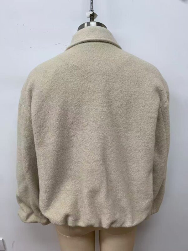 Elegant beige wool coat displayed on a mannequin, perfect for fall and winter fashion, showcasing classic style and high-quality material.
