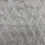 Close-up of silver lace fabric with intricate floral patterns, ideal for wedding dresses and evening gowns.
